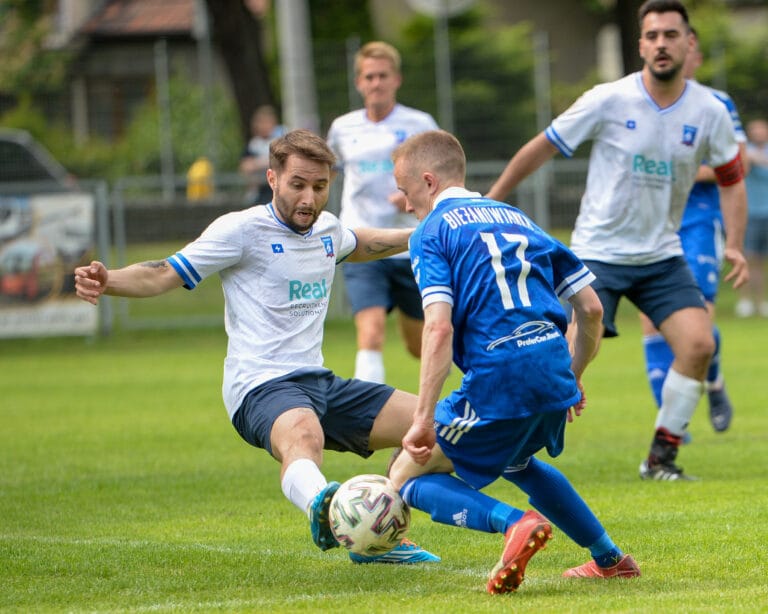 Edoardo Battaglion of Krakow Dragoons FC tackling a Bieżanowianka opponent