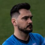 Kuba Drobny of Krakow Dragoons FC listening to coach talk before match