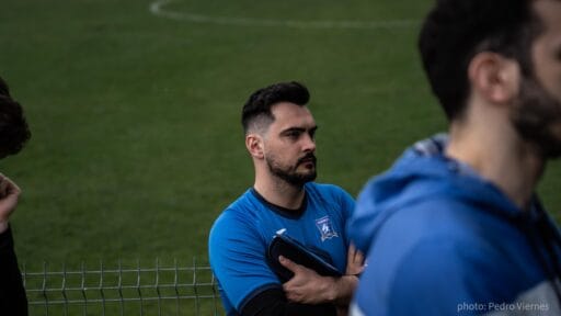Kuba Drobny of Krakow Dragoons FC listening to coach talk before match