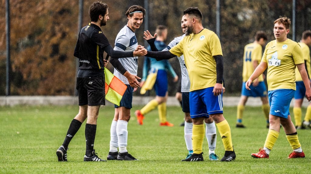 Krakow Dragoons FC and Albertus players greet after match