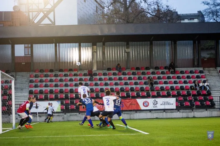 The ball flies over the area in a corner kick during Krakow Dragoons FC vs Strzelcy