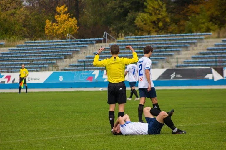 Robert Ambrosie of Krakow Dragoons FC lying injured on the field