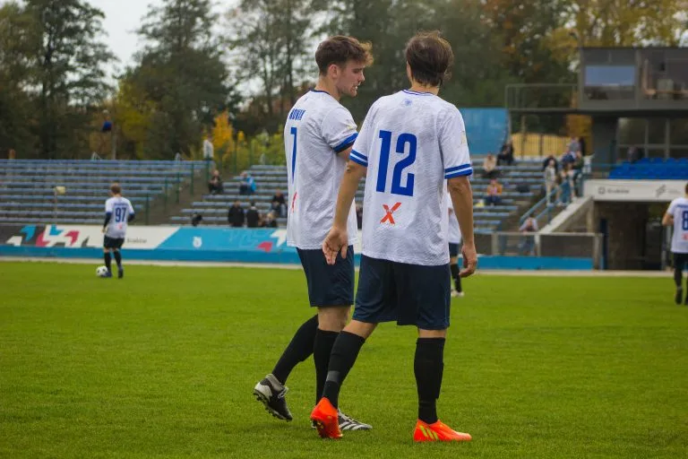Michał Nowak and Alessandro Puerini of Krakow Dragoons FC talking at half-time