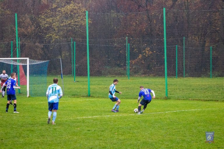 Robert Ambrosie of Krakow Dragoons FC dribbling a Borek opponent inside the box