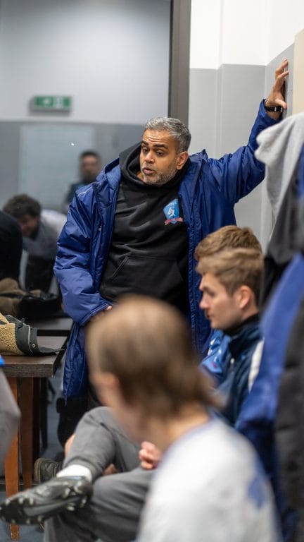 Coach Ashvin Asani of Krakow Dragoons FC giving instructions to their players at half-time