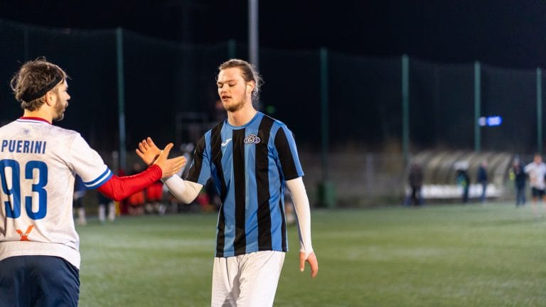 Players of Krakow Dragoons FC and Afc DWS greeting each other after the match