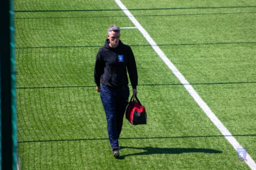 Scott Halcrow of Krakow Dragoons FC carrying the team's medibag during a match