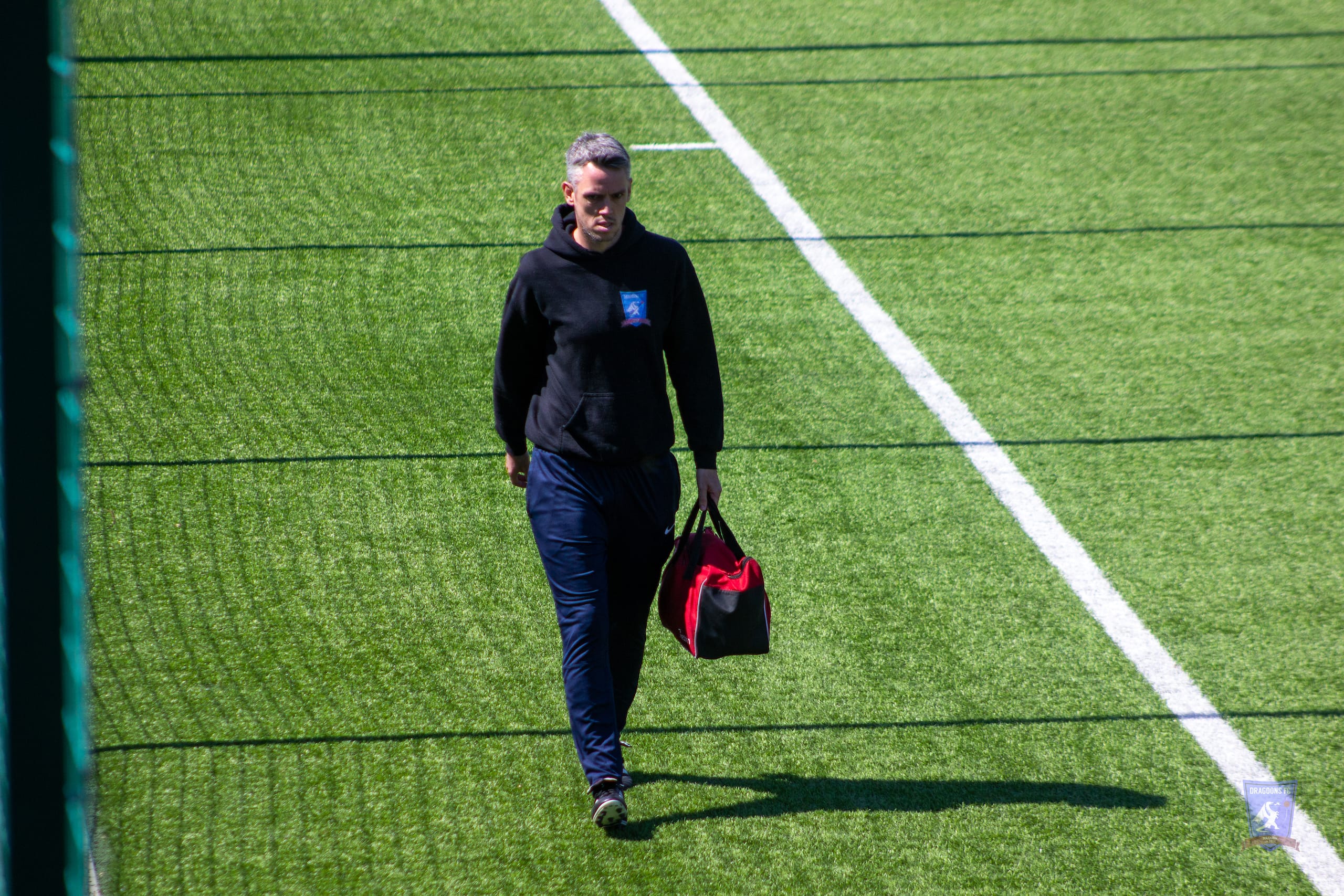 Scott Halcrow of Krakow Dragoons FC carrying the team's medibag during a match