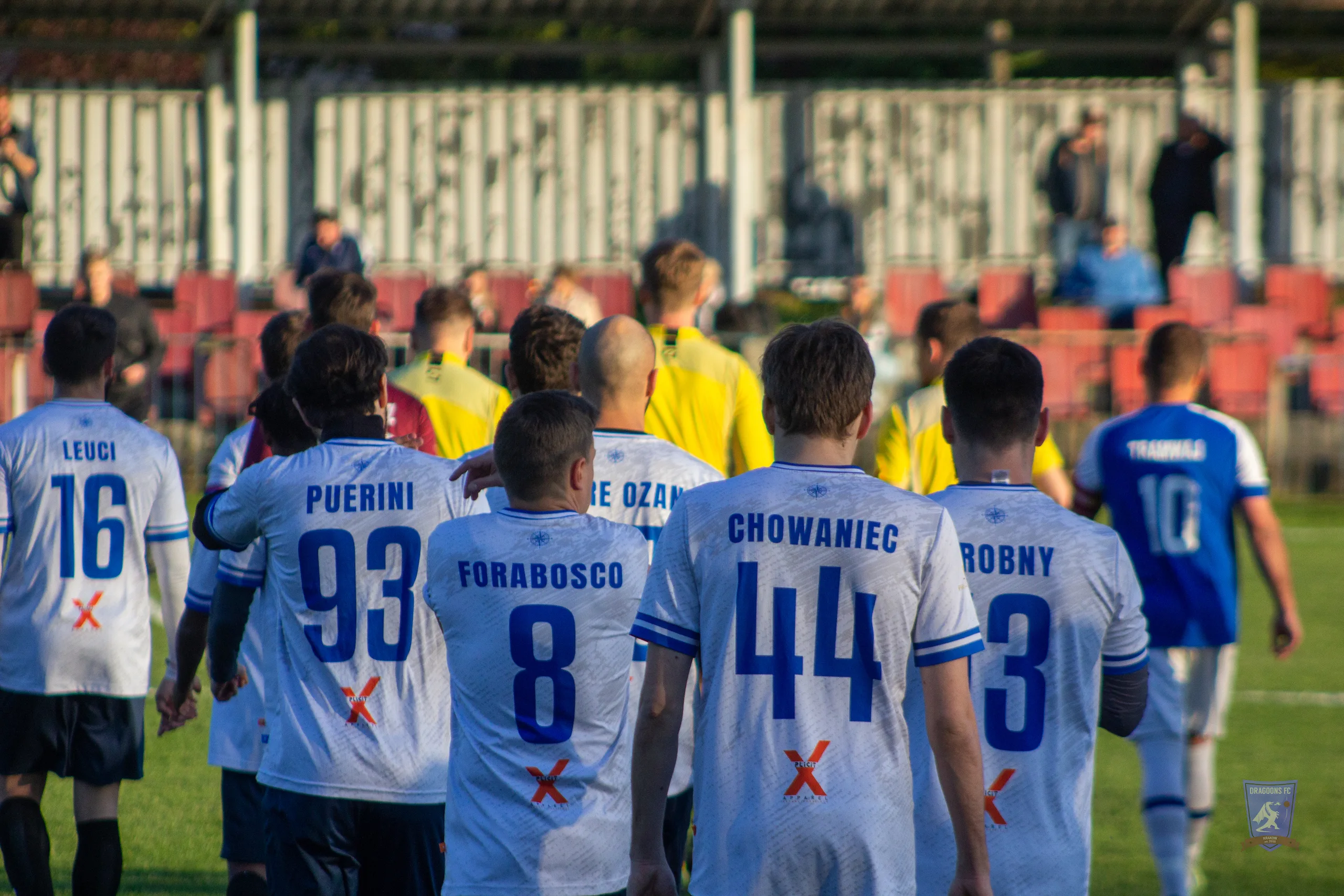 Krakow Dragoons FC players enter the field vs Tramwaj