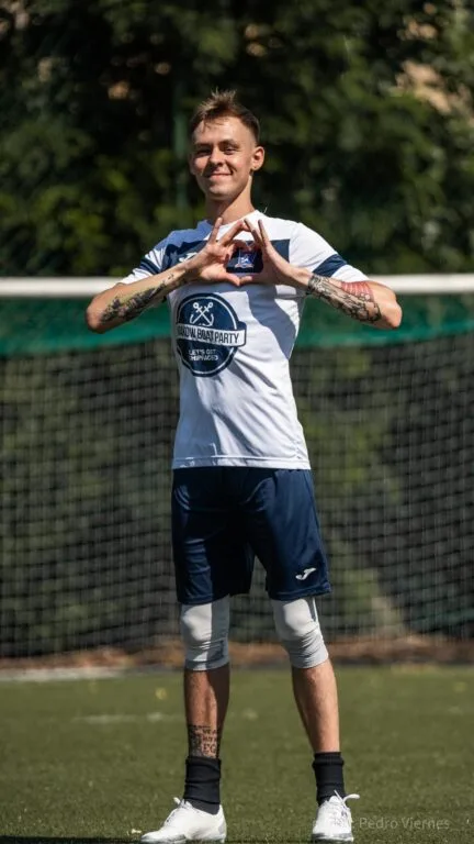 Vałdzis Fuhaš of Krakow Dragoons FC making a heart sign next to the Dragoons logo