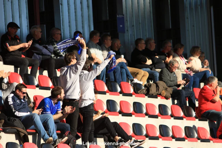 Krakow Dragoons FC fans waving their scarves on the stands