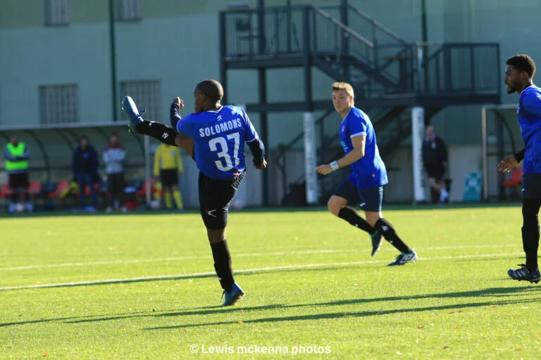 Keanu Solomons of Krakow Dragoons FC shoots a ball away