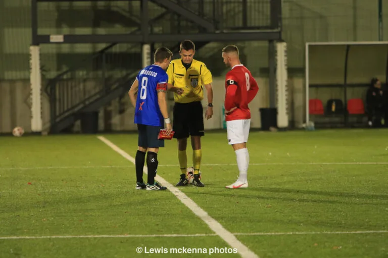 Referee and captains of Krakow Dragoons FC and FC United of Manchester doing the coin toss