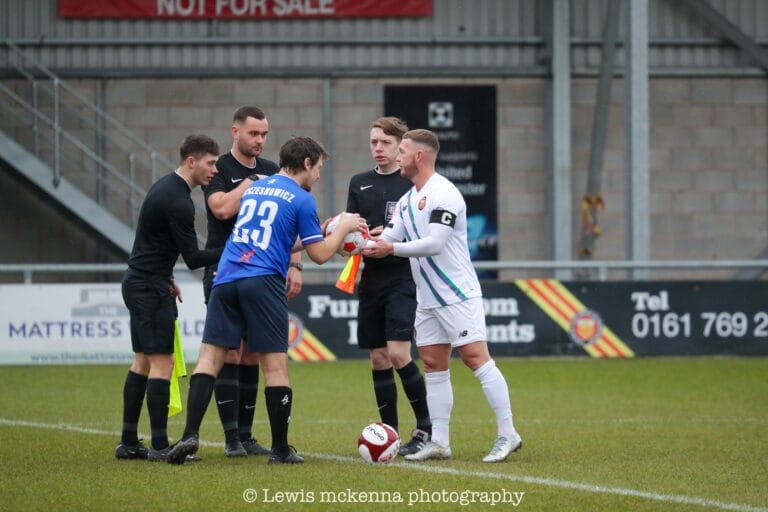 FC United of Manchester and Krakow Dragoons FC captains and referees doing the usual pre-match coin toss