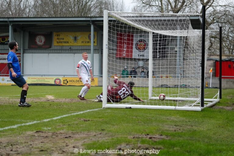 Aaron Bennett of FC United of Manchester taps the ball into the back of the Dragoons net