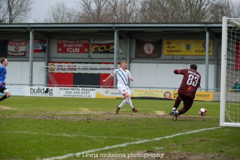 Aaron Bennett of FC United of Manchester once again taps the ball into the back of the Dragoons net