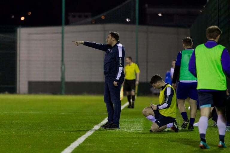 Dave Burch of Krakow Dragoons FC giving instructions to the players by the sideline