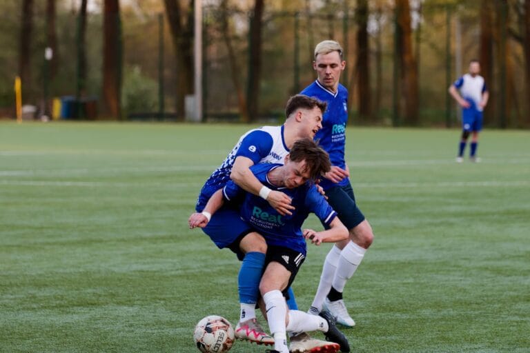 Jan Krzyżanowski of Krakow Dragoons FC being tackled by an opponent