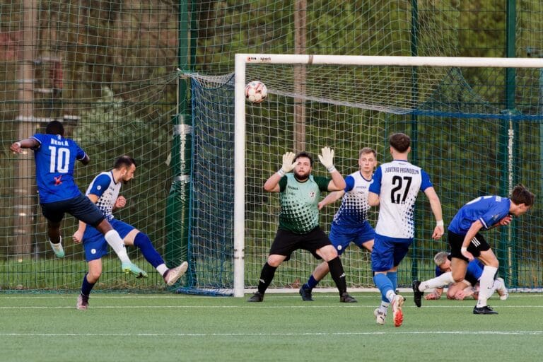 Flavio Nkola of Krakow Dragoons FC shoots a ball at goal inside the opponents populated box