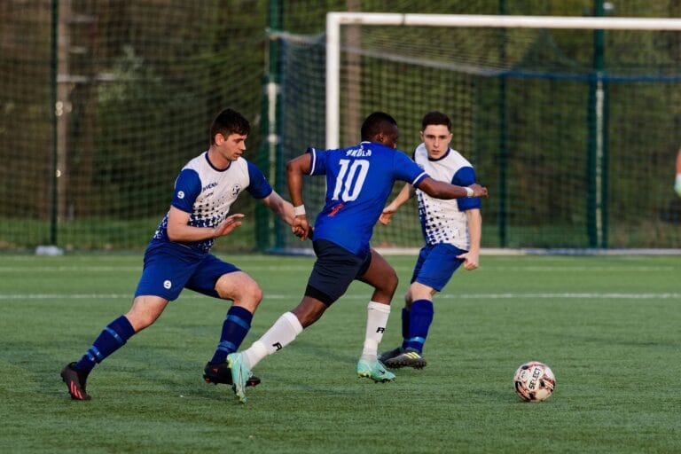 Flavio Nkola of Krakow Dragoons FC attempts dribbling two opponents