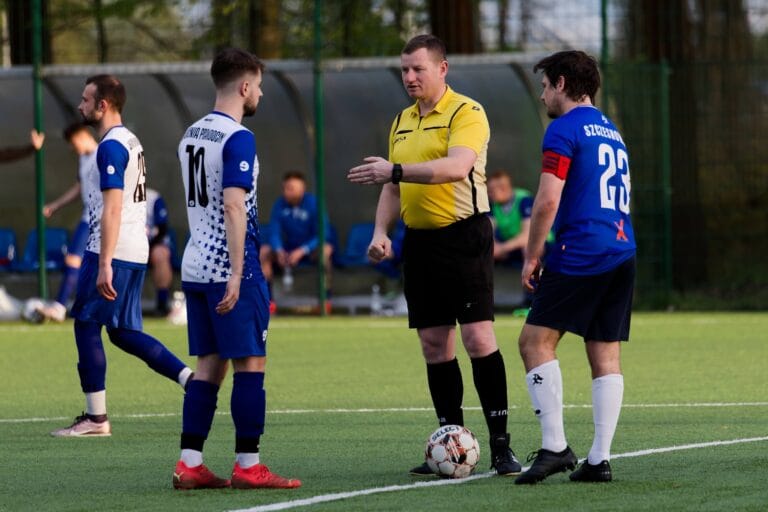 Krakow Dragoons FC and Juvenia Prandocin captains and referee during the coin toss