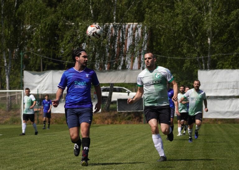 Kuba Drobny of Krakow Dragoons FC controlling the ball on the lookout for a Galicja Raciborowice player nearby