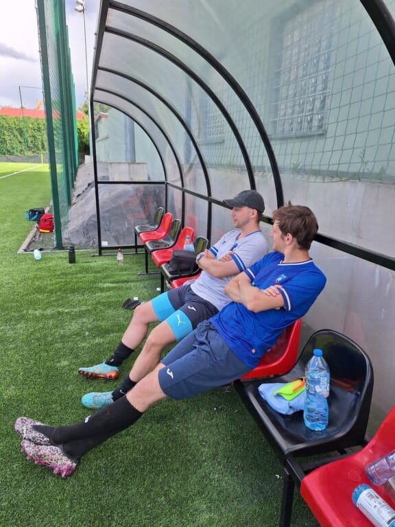 Krakow Dragoons FC players Szymon Urzędowski and Bartek Chowaniec having an amusing chat at the dugout