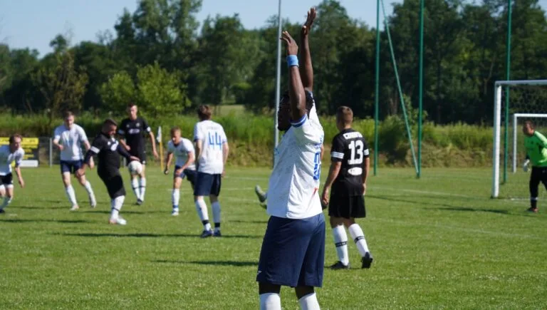 Isreal Olusoji claiming a penalty with his arms lifted up