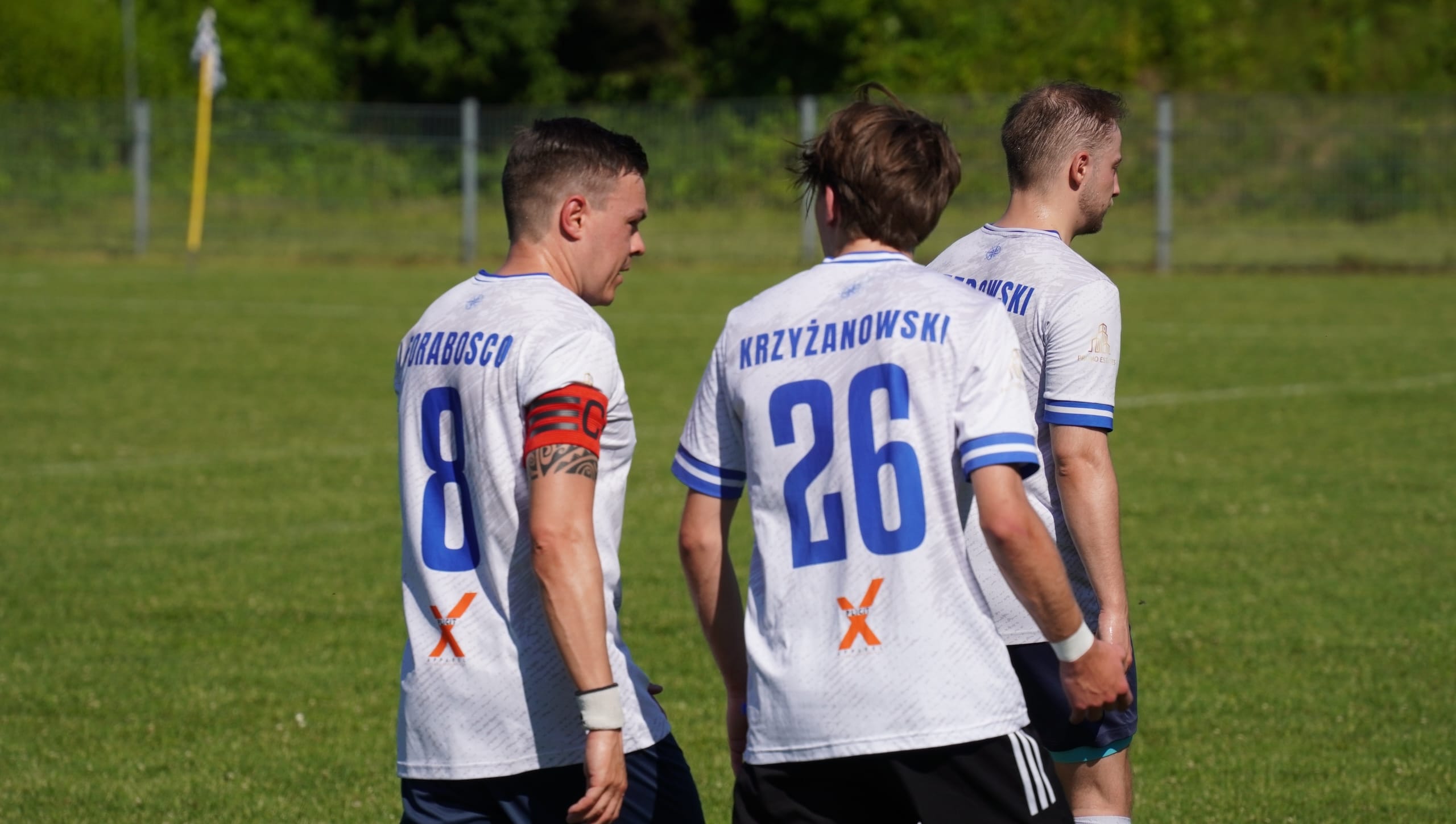 Enrico Forabosco and Jan Krzyżanowski of Krakow Dragoons FC having a chat while entering the pitch