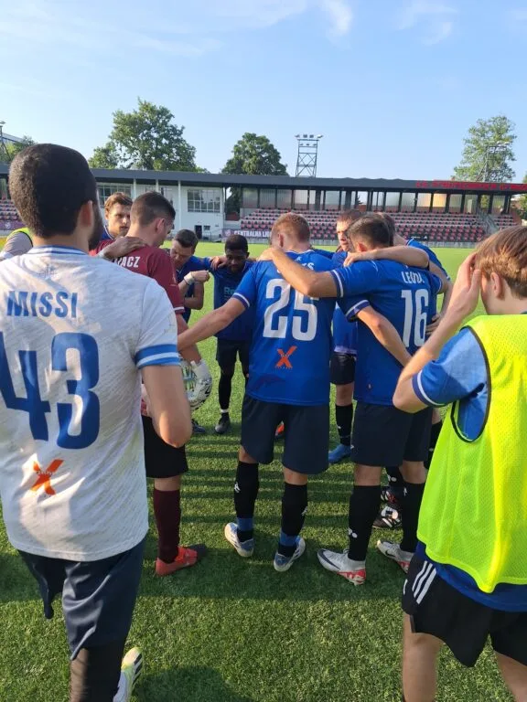 Krakow Dragoons FC players gather up in a circle before kickoff