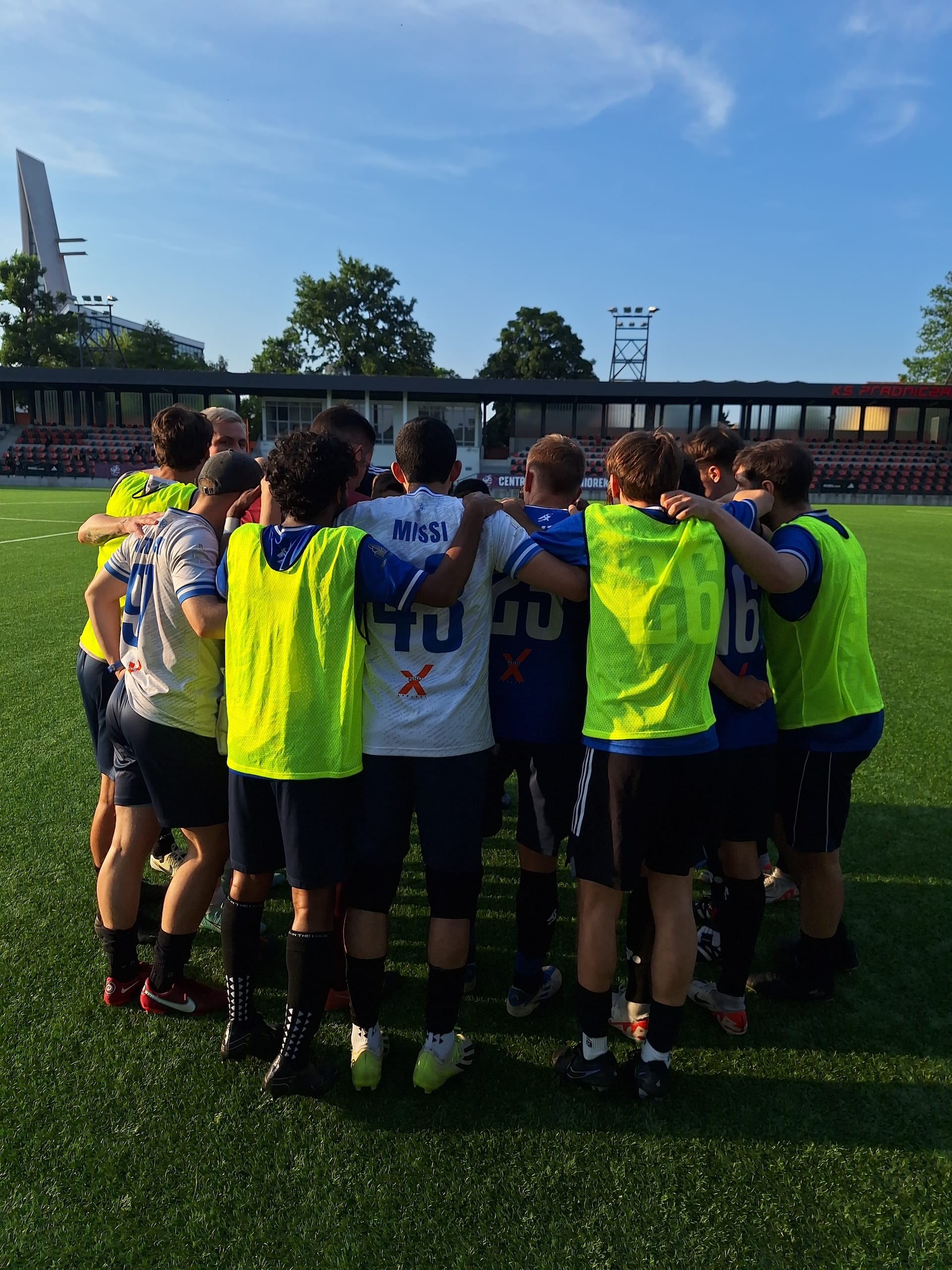 Krakow Dragoons FC players gather up in a circle before kickoff