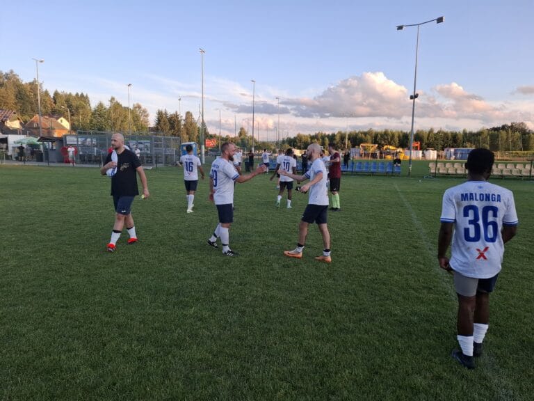 Krakow Dragoons FC players greeting each other post-match