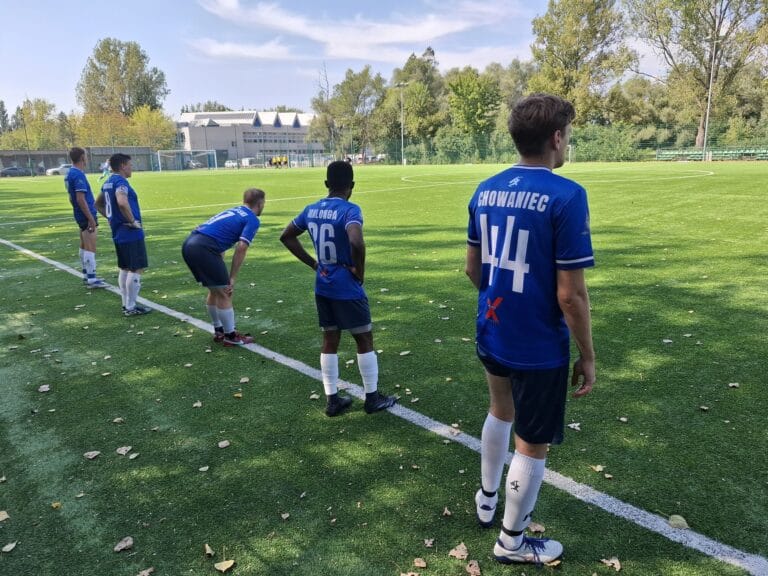 Krakow Dragoons FC players on the sideline preparing for warmup exercises