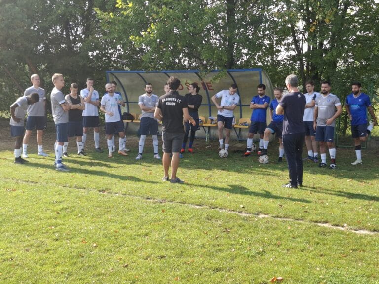 Krakow Dragoons FC head coach Hugo Cruz talking to his players by the sideline