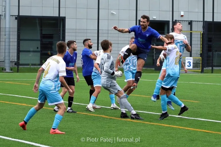 Simon Calabrese of Krakow Dragoons FC arrives late to a ball cross inside Błękitni II Modlnica's box