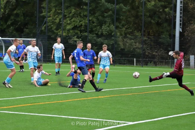 Marcin Obyrtacz of Krakow Dragoons FC attempts a save, under the eye of 9 players inside the Dragoons box