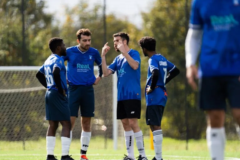 Krakow Dragoons FC players discussing game tactics