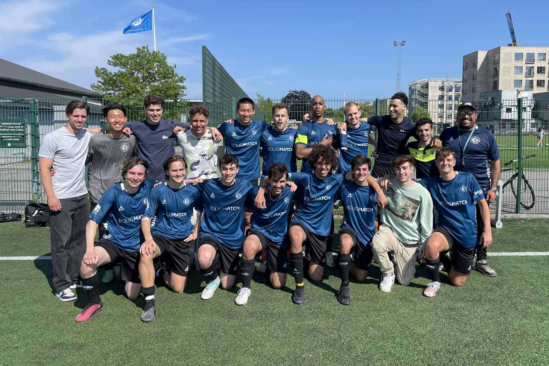 The team of CBS Sport Copenhagen posing for a photo in a football field