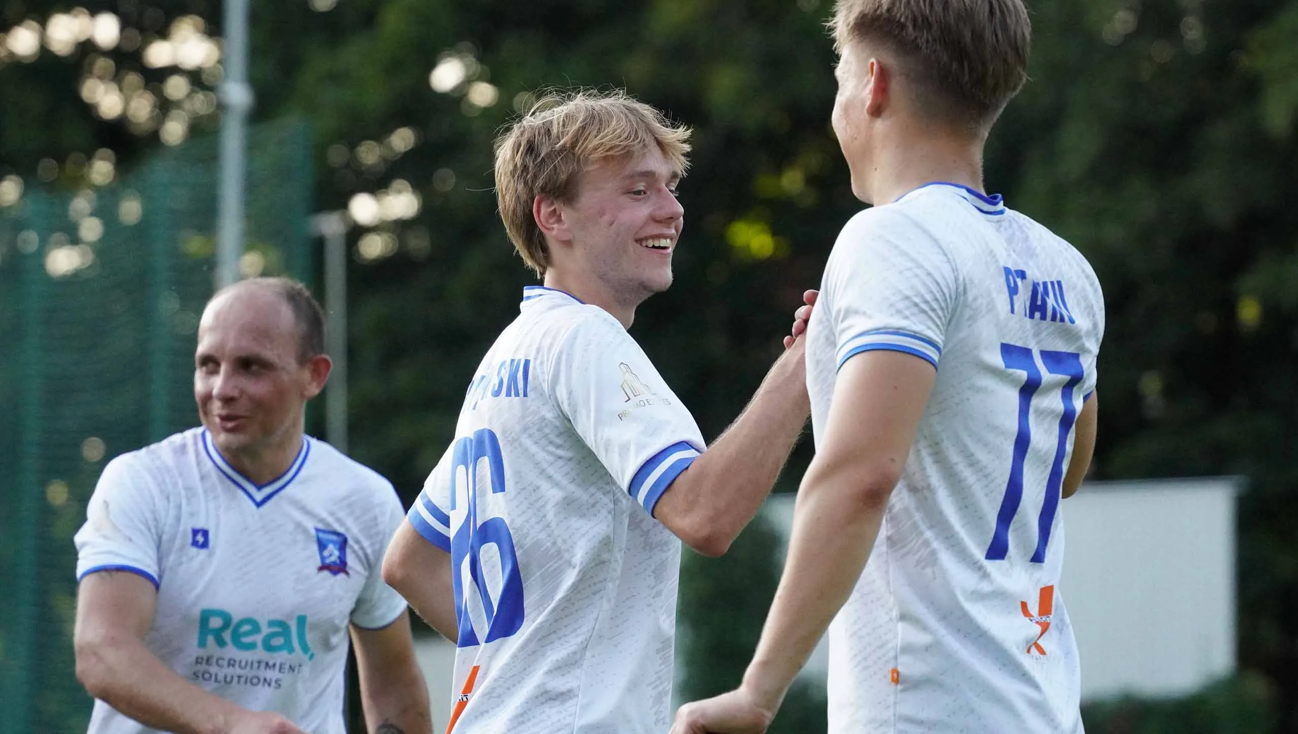 Krakow Dragoons FC players greeting post match with smiles on their faces