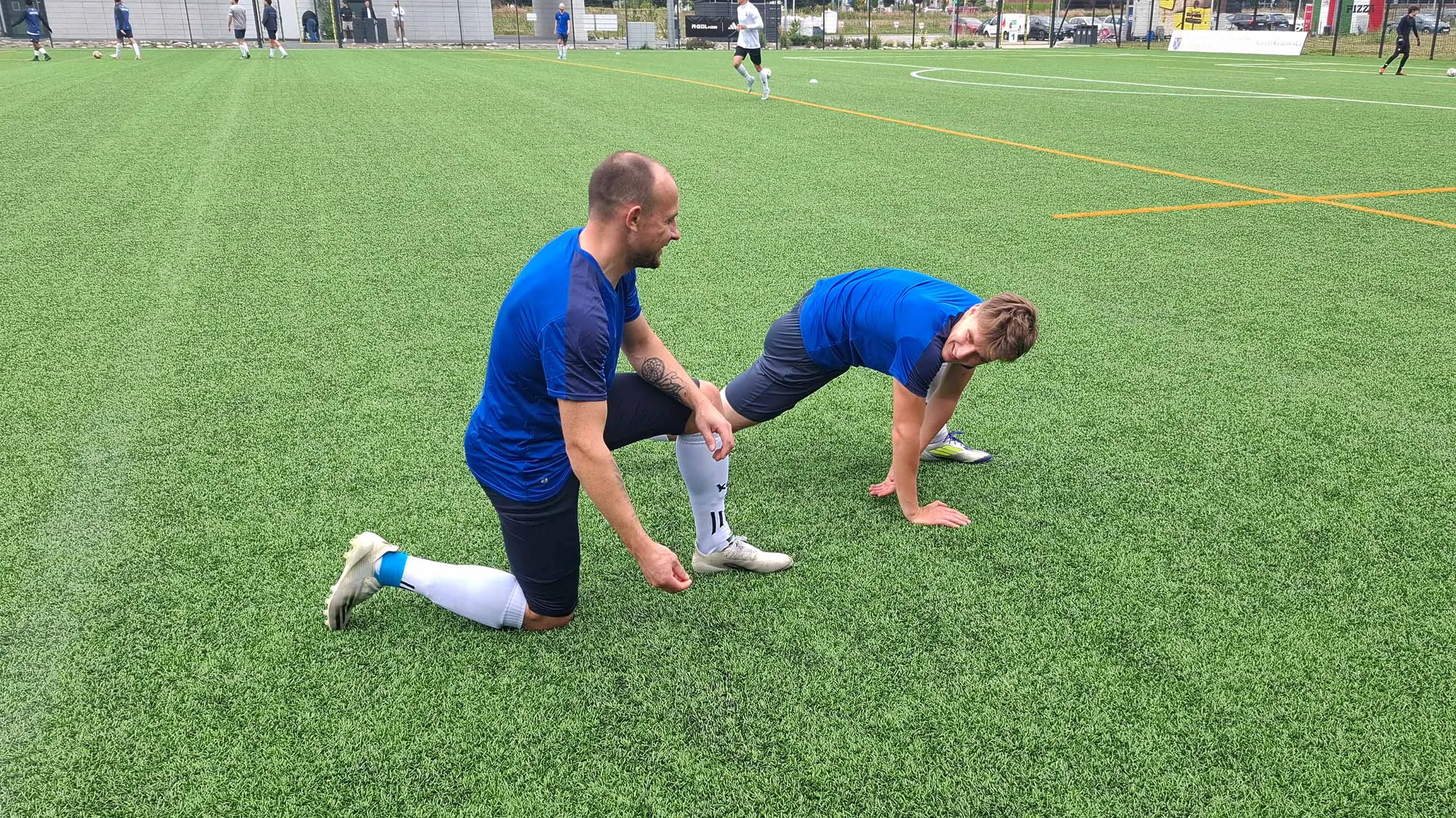 Serhii Yelysieiev and Jan Kołodziejski of Krakow Dragoons FC having a cheerful conversation during match warmup