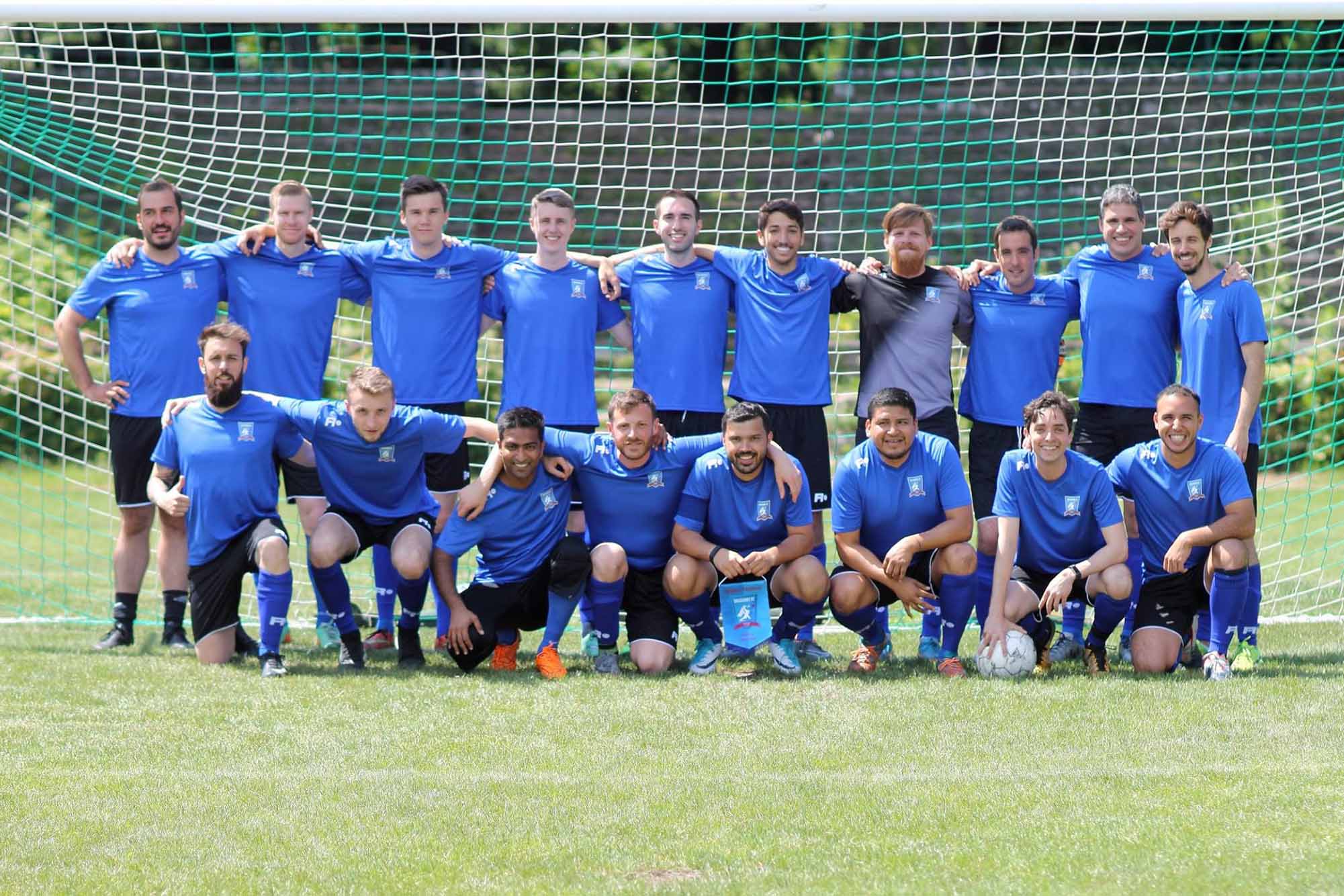 Krakow Dragoons FC players posing for a photo in front a football goal