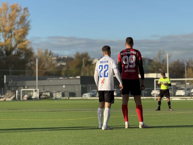 Two players of Krakow Dragoons FC and KS Podgórze side-by-side during match